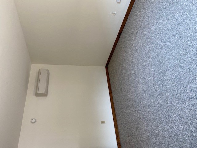 a white room with a mirror on the wall