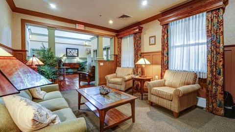 A living room with a couch, chair, and coffee table.