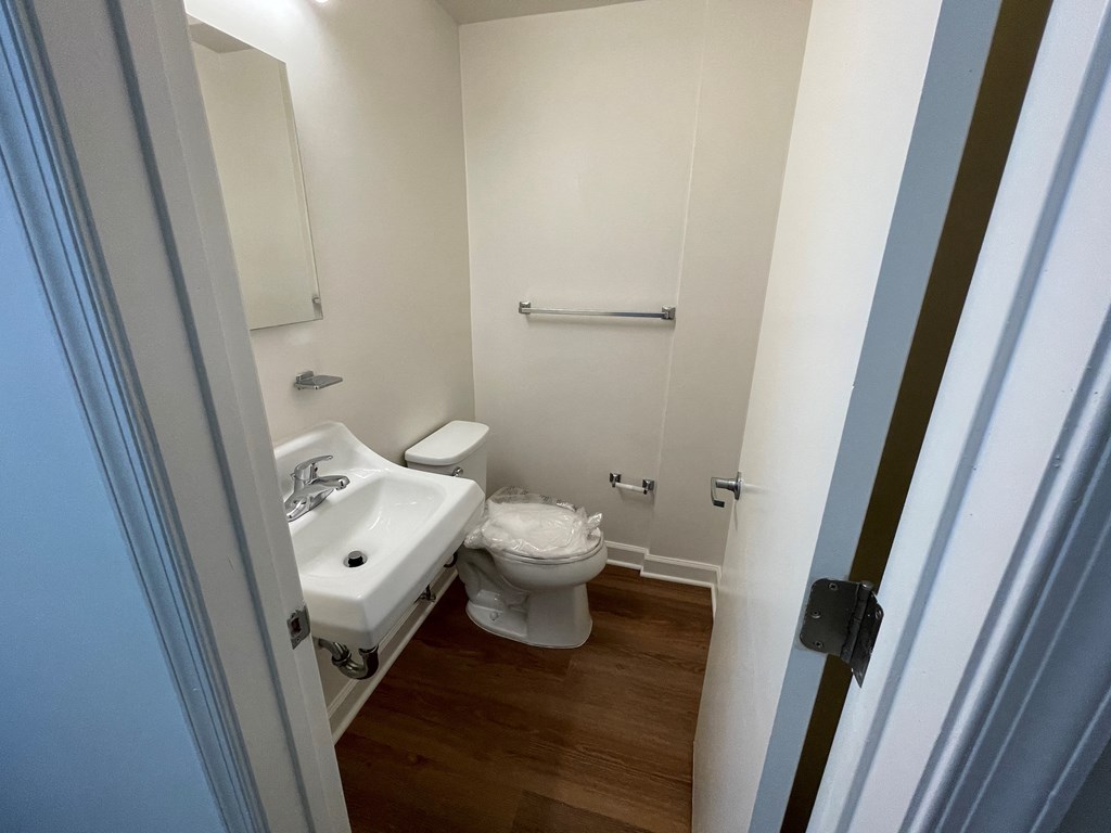 a small bathroom with a toilet sink and mirror