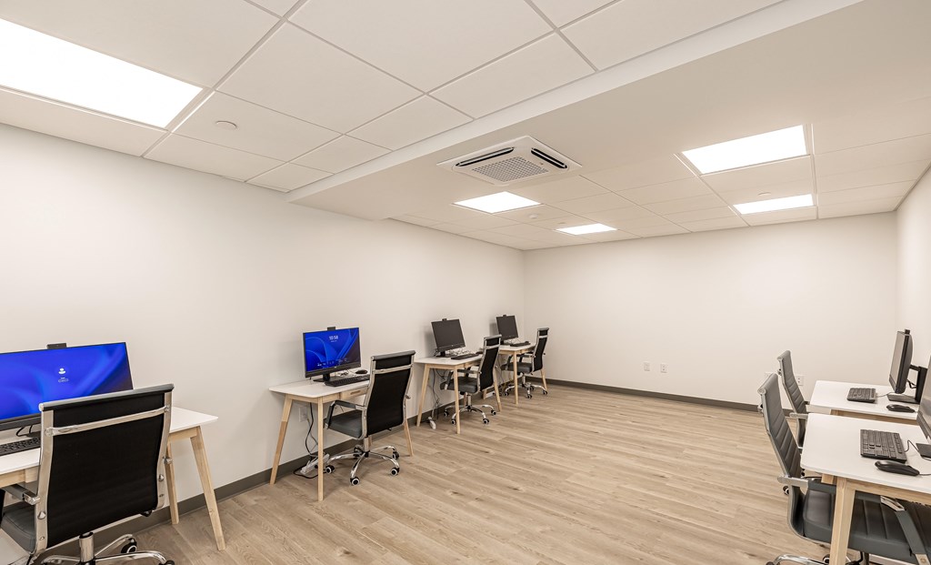 A room with multiple desks and computers.