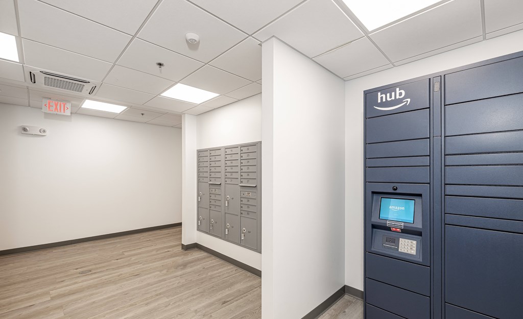 A room with a row of Amazon lockers on the right side.