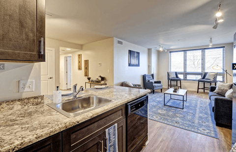 a kitchen with a sink and a view of a living room