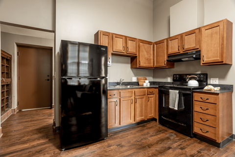 a kitchen with black appliances and wooden cabinets