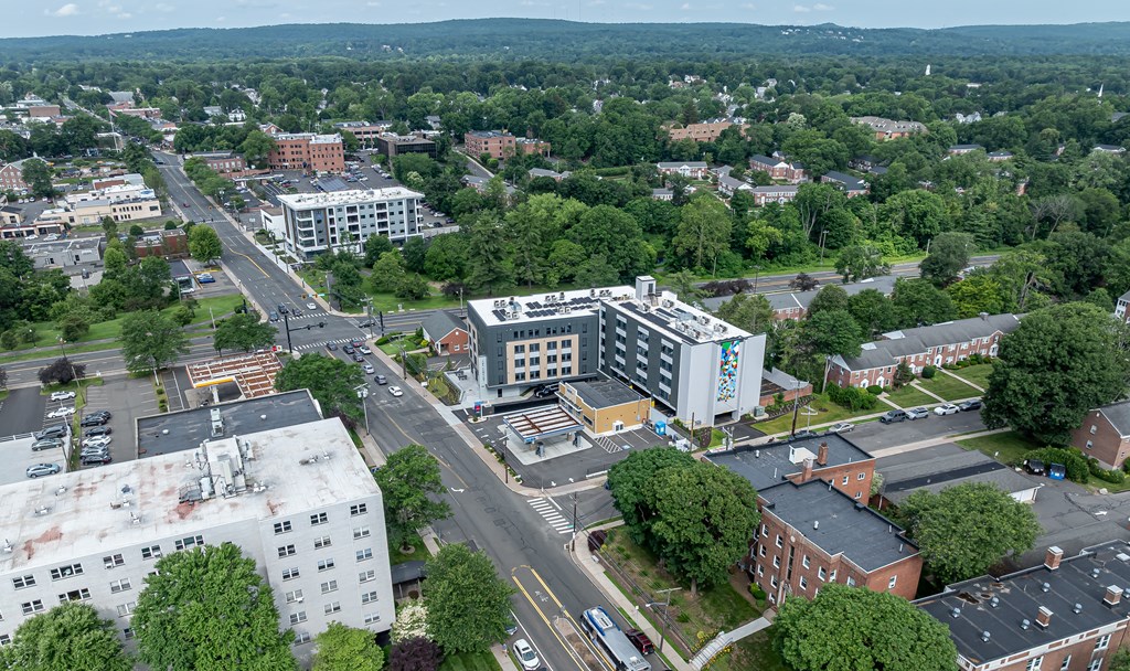 A city street with a large building on the right.