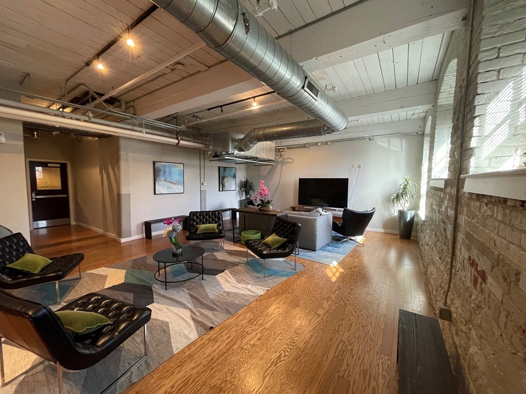 a living room with couches and chairs and a tv
