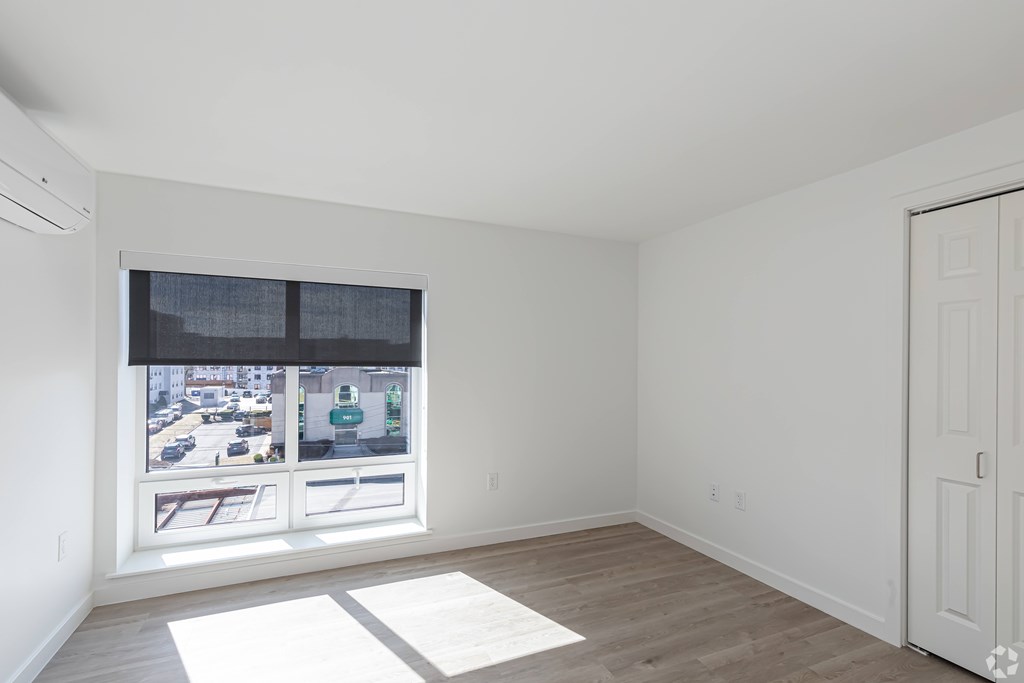 A room with a window overlooking a street.