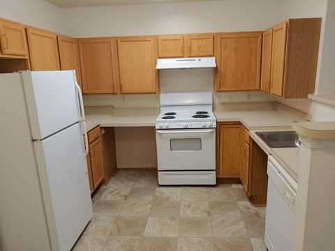 a kitchen with a stove refrigerator and sink