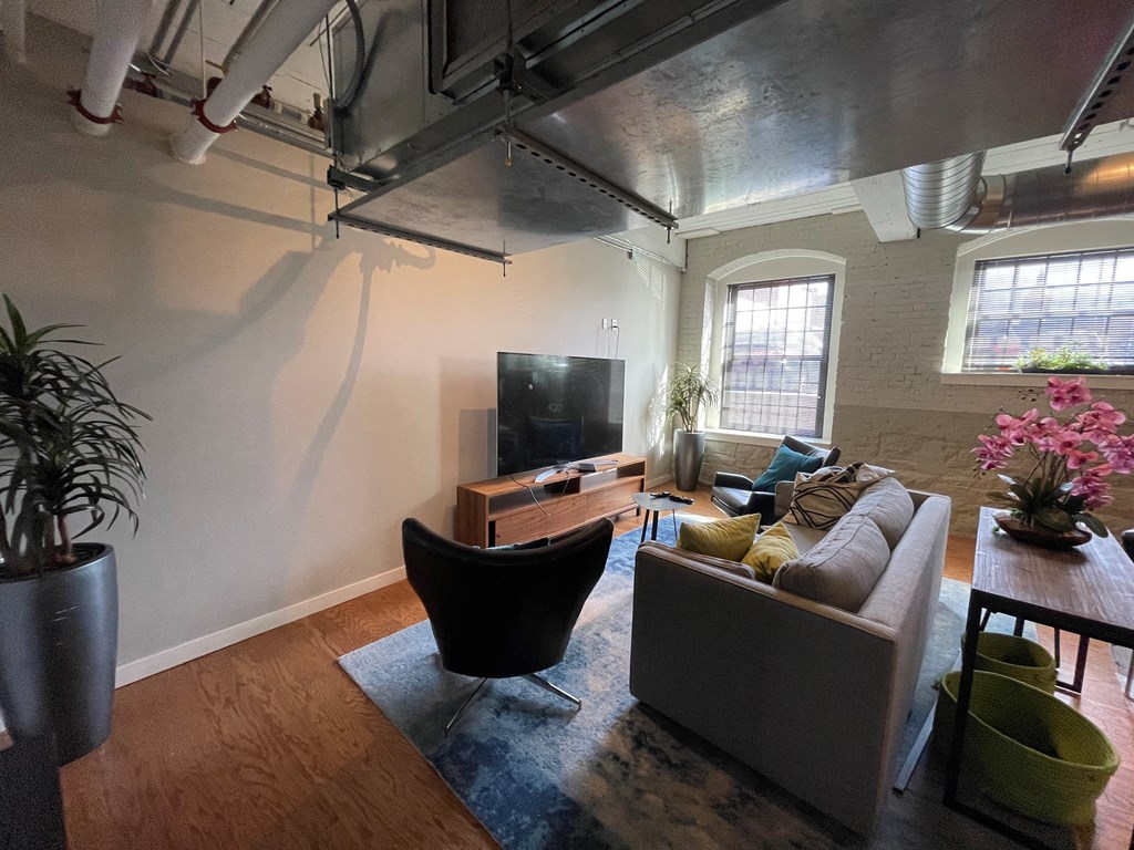 a living room with a couch and a chair and a tv