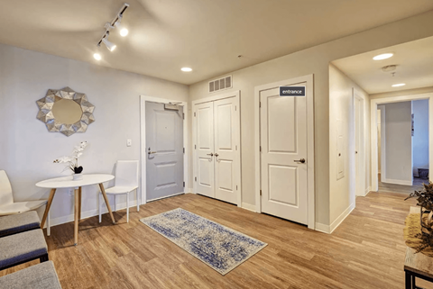a living room with white doors and a table