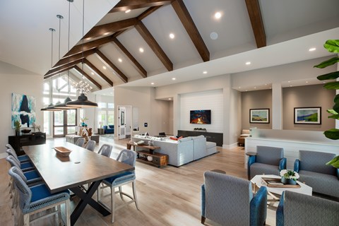 A modern dining room with a long table and chairs at 55 Fifty at Northwest Crossing, Houston, TX 77092