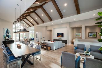 a living room with a dining room table and a couch at 55 Fifty at Northwest Crossing, Texas