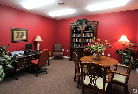 a room with a table and chairs and a bookcase