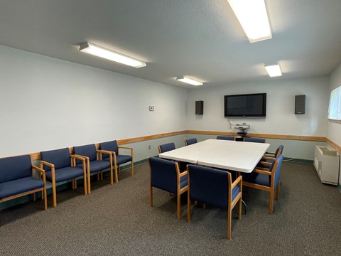 a meeting room with a large table and chairs