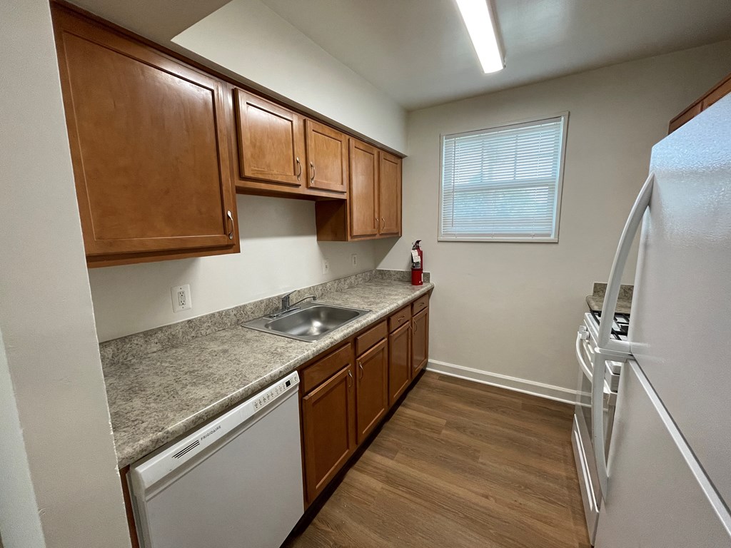 a kitchen with wooden cabinets and stainless steel appliances