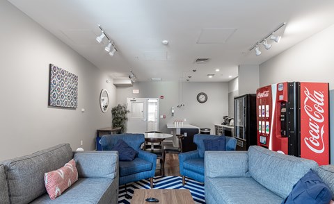 A living room with a Coca-Cola vending machine.