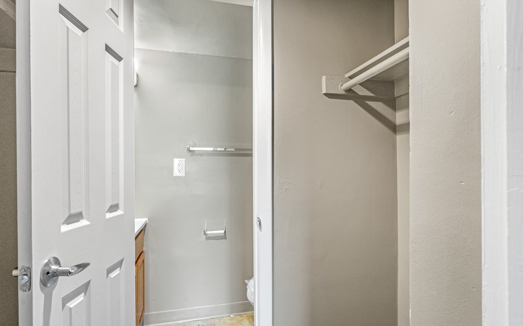 A white door is open to a hallway.