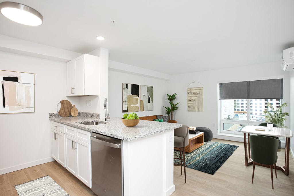 A modern kitchen with white cabinets and a large island.