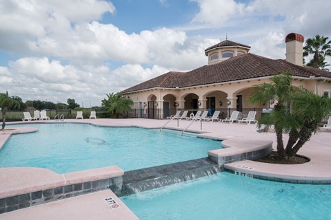 a large swimming pool in front of a house