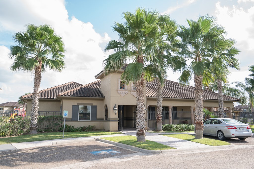 a house with palm trees and a car parked in front of it