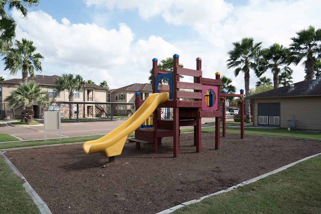 a playground with a slide in a park