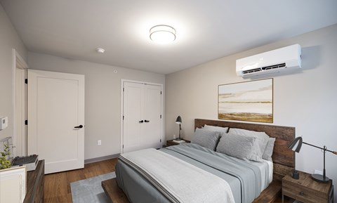 A bedroom with a large bed and a wooden headboard.