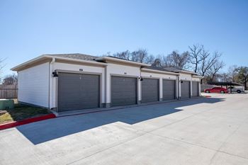 a row of garage doors on the side of a building at 55 Fifty at Northwest Crossing, Houston, TX 77092