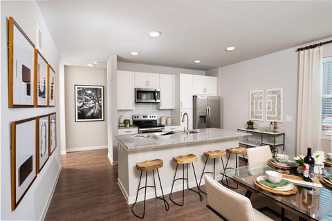 a kitchen and dining area a kitchen and dining area at 55 Fifty at Northwest Crossing, Texas, 77092