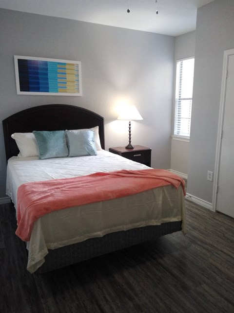 a bedroom with a bed and a window