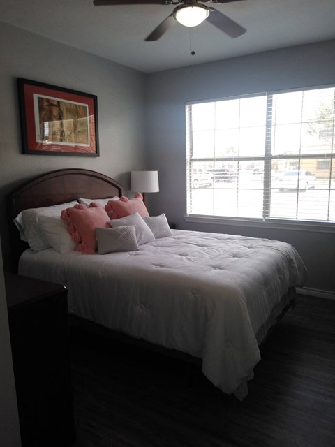 a bedroom with a large bed and a window