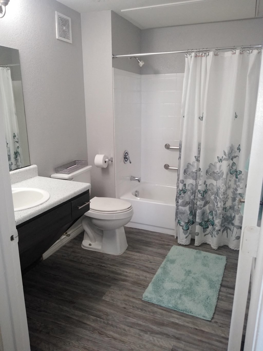 a bathroom with a toilet and a tub and a sink