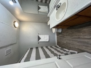a bathroom with a sink and a bed
