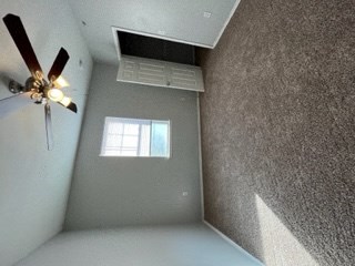 a room with a ceiling fan and a window