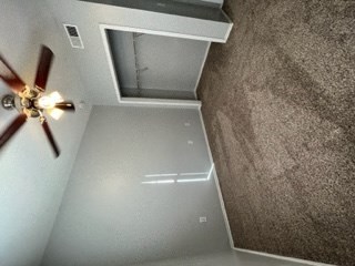 a room with a ceiling fan and a window