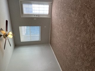 a empty room with a window and a ceiling fan