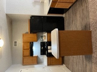 a kitchen with a refrigerator and a microwave in a room