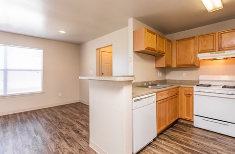 the preserve at ballantyne commons apartment kitchen with white appliances and wooden cabinets