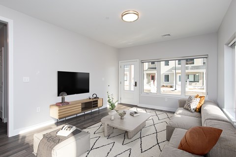 A modern living room with a flat screen TV and a coffee table.