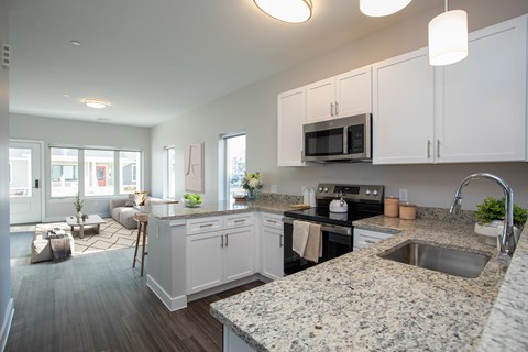 Open concept kitchen with granite countertops at MLK Apartments, Hartford, Connecticut