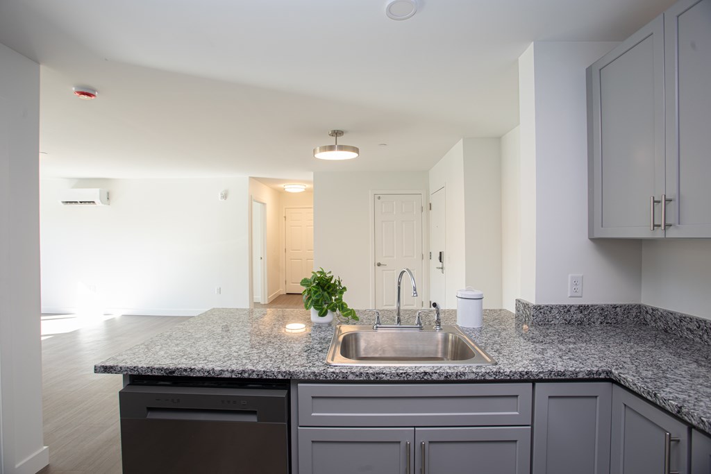 A kitchen with a granite countertop and a sink.