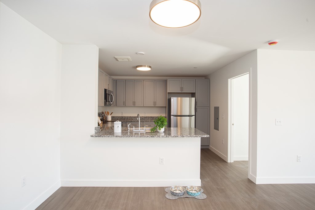 A kitchen with a white counter and a white ceiling.