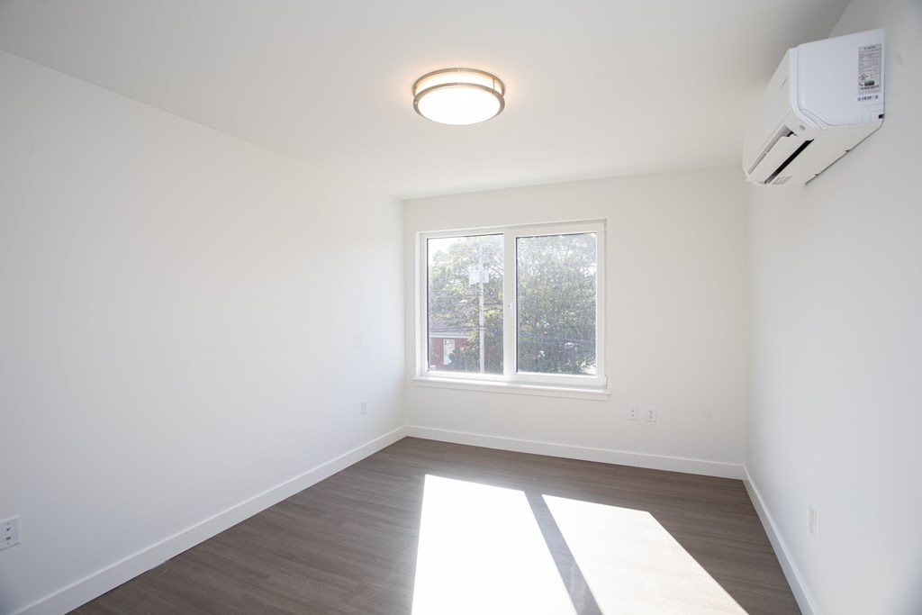 A room with a window and a ceiling light.
