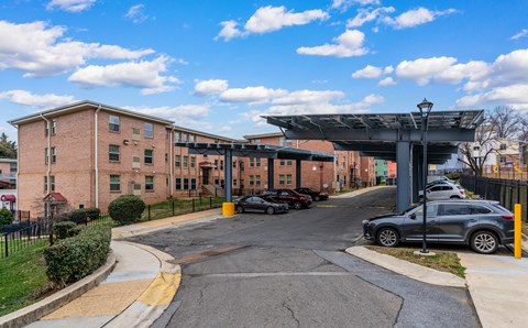 A parking lot with cars and a building in the background.