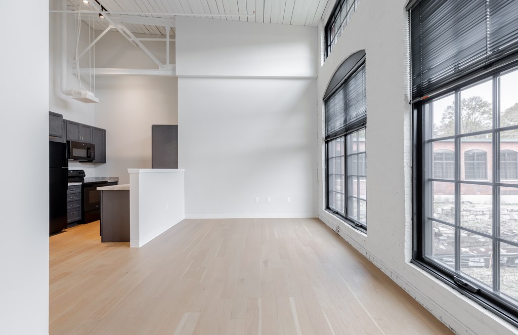 A room with a wooden floor and a large window.