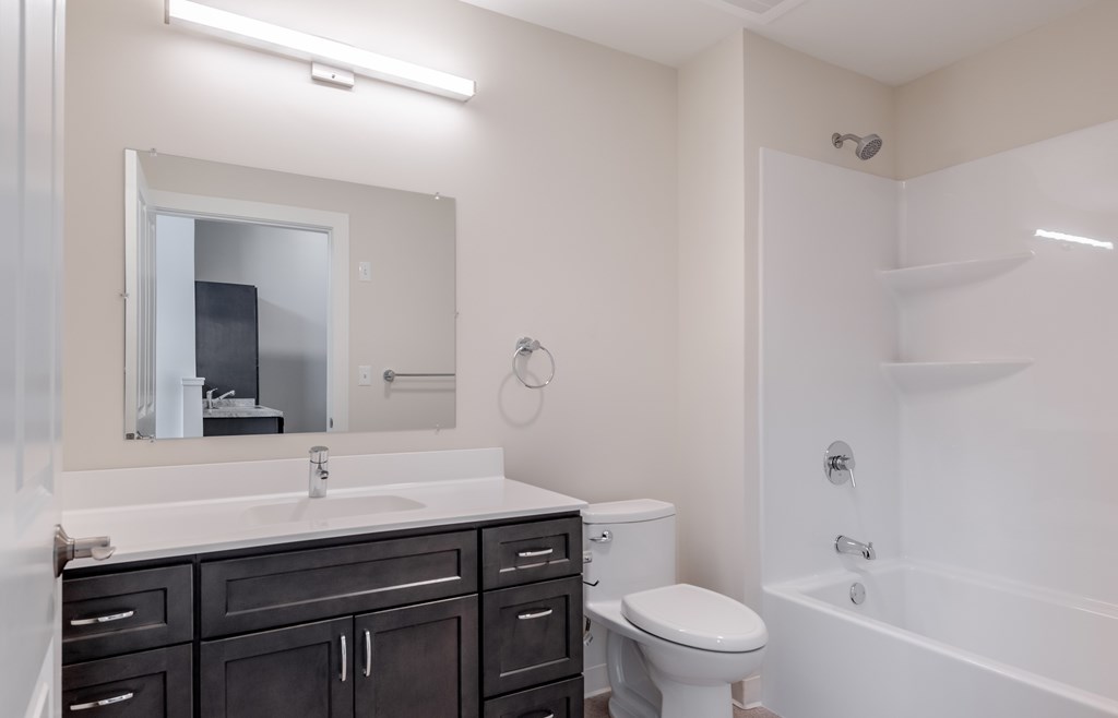 A white bathroom with a white toilet and sink.