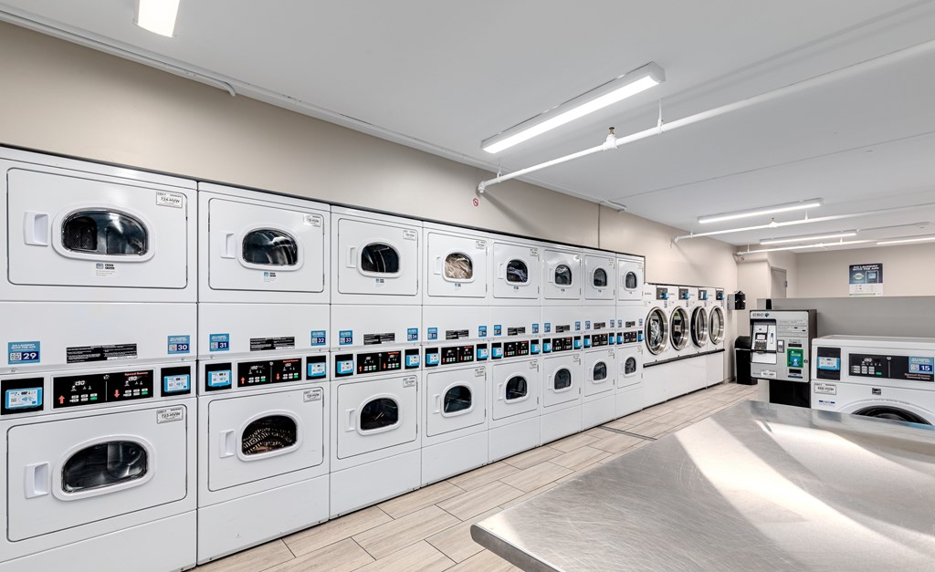 A row of washing machines in a laundromat.