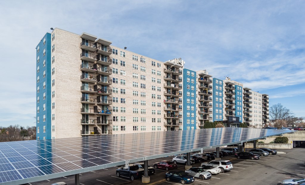 A large building with a parking lot in front of it.