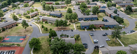 A bird's eye view of a residential area with a basketball court.