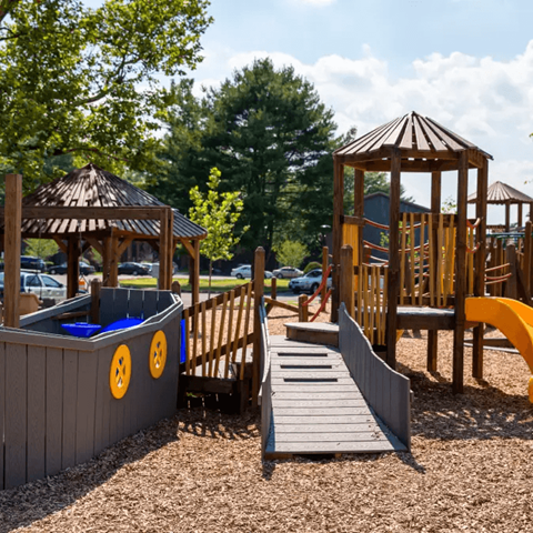 A playground with a wooden structure and a slide.