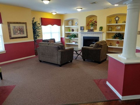 A living room with a fireplace and two couches.