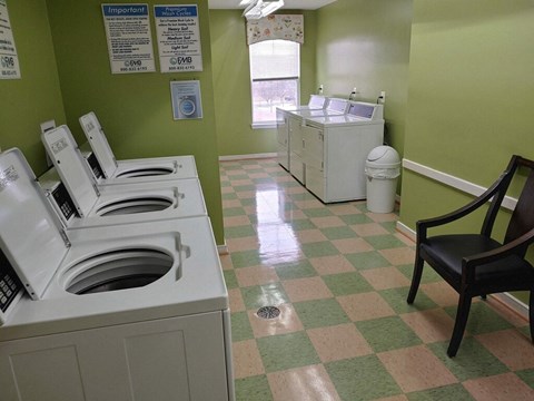 a laundry room with washers and a sink